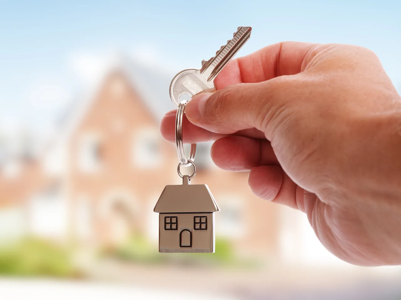 Hand holding a set of house keys