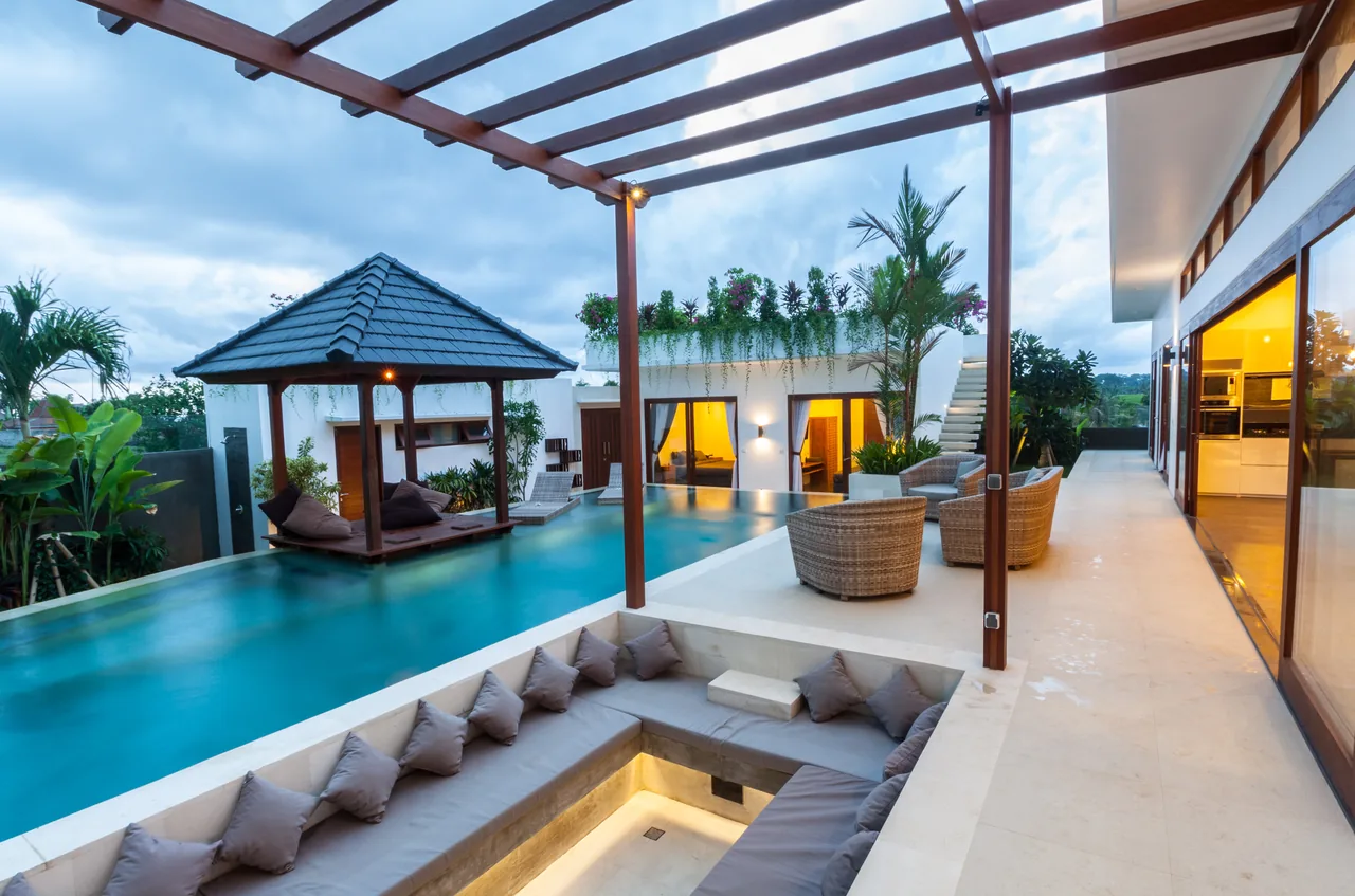 Poolside terrace with tropical landscaping